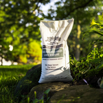 Lifetyme Sod-Builder Shady Lawn Mixture bag on mossy rock, a very shade tolerant fine texture grass seed for patchy low-light and north-facing lawns